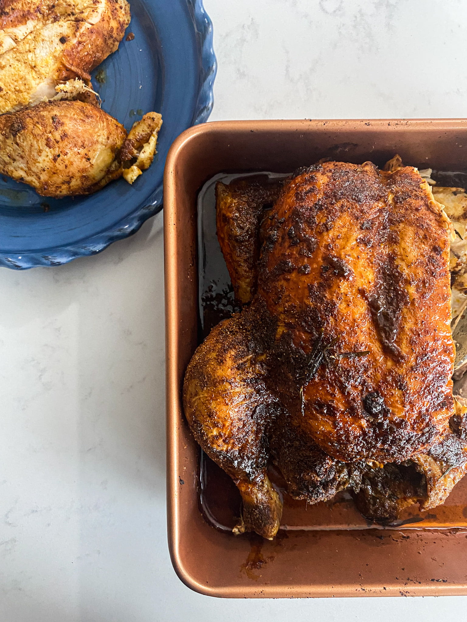nigerian roasted chicken carved with a serving on a blue plate