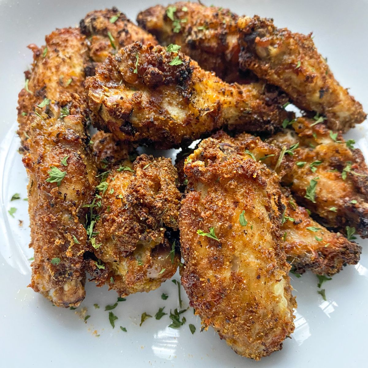 air fried chicken suya wings on a white plate