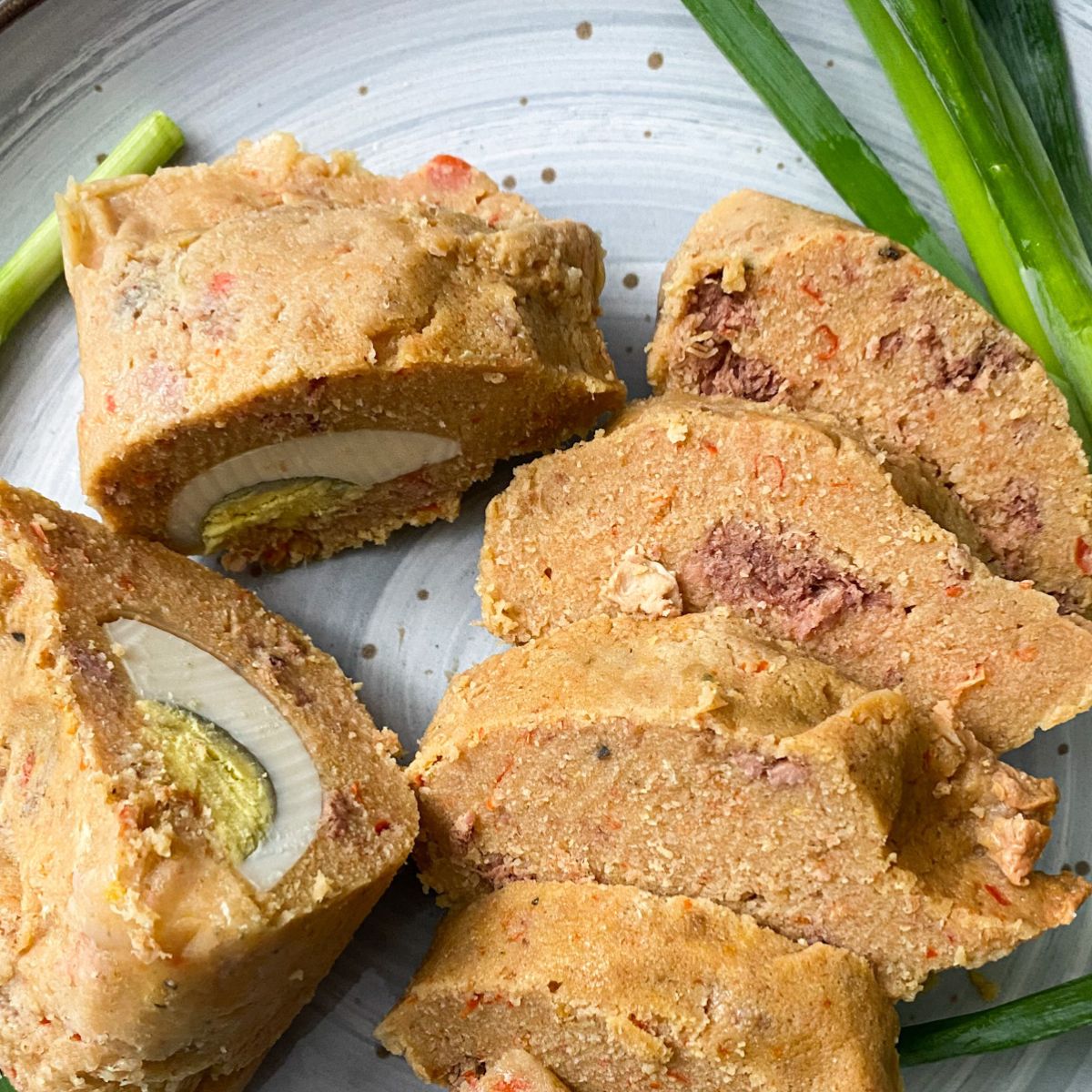 plated moi moi with spiring onion garnish