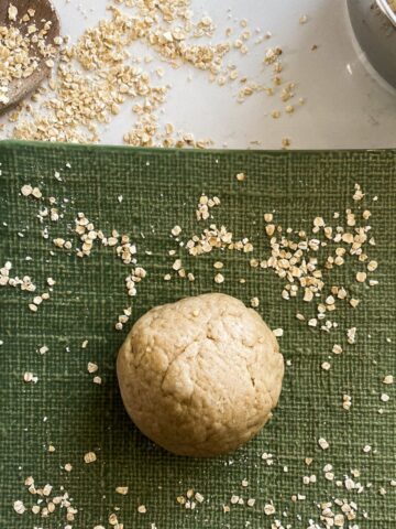 oat fufu placed on a green square dish garnished with oats